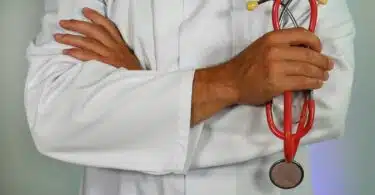 doctor holding red stethoscope