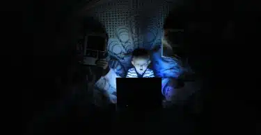 boy playing at laptop inside room