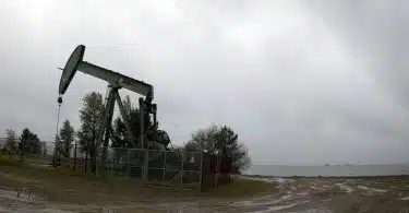 an oil pump sitting on top of a dirt field