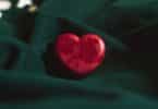 red heart ornament on green textile